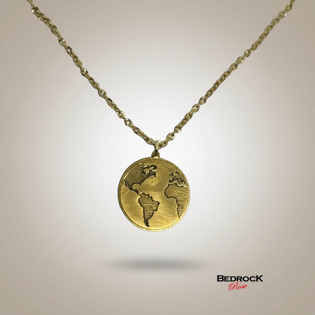 Bedrock Rose gold world map pendant necklace with a detailed engraved globe and a twisted chain. Ideal for travel lovers.