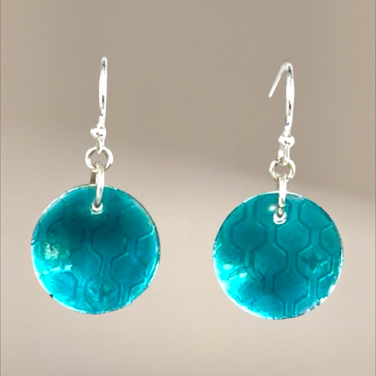 Bedrock Rose transparent green circle dangle earrings with honeycomb pattern and silver hooks.