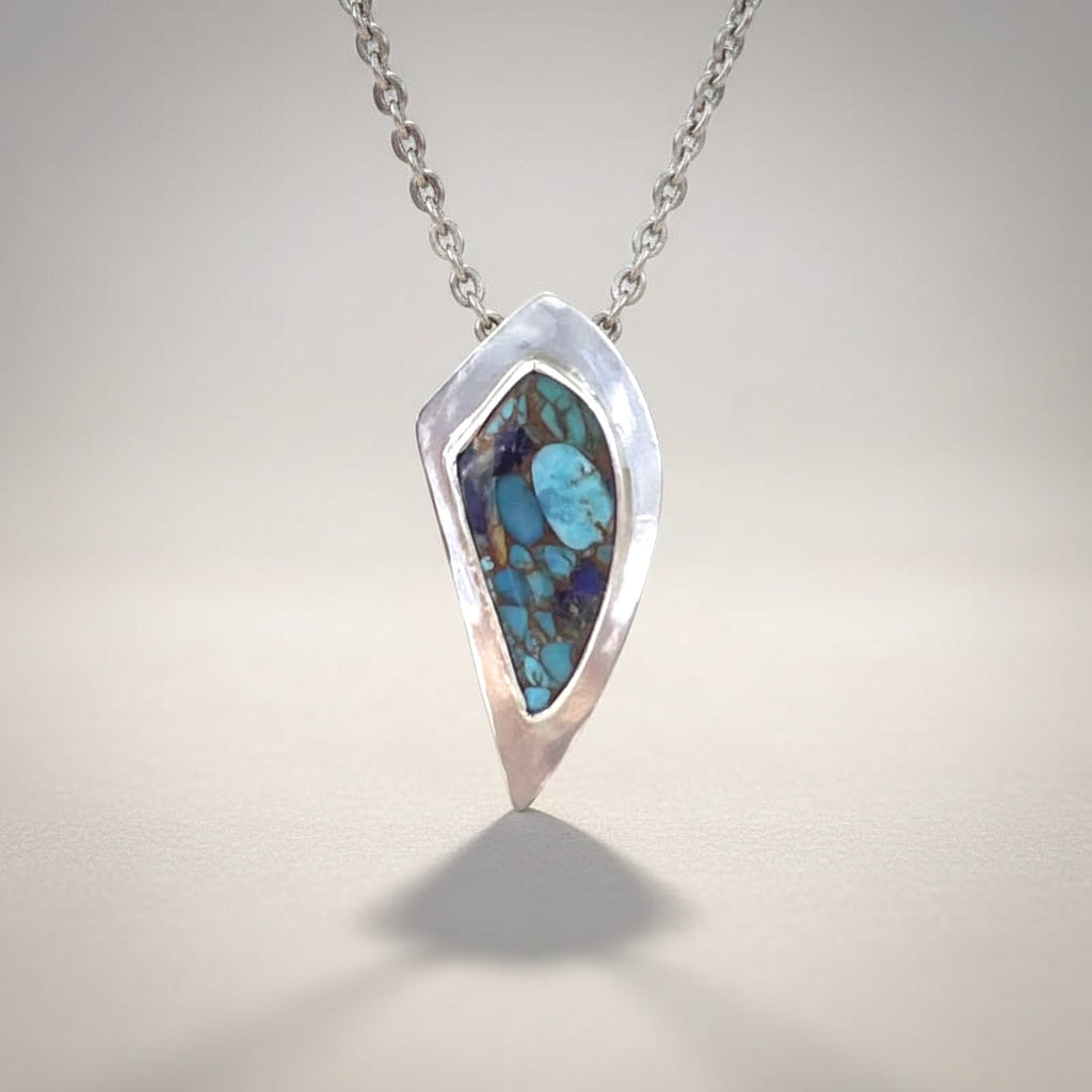 Bedrock Rose sterling silver pendant with Kingman Turquoise, Lapis, and Bronze inlay. Features an 18" hypoallergenic chain.