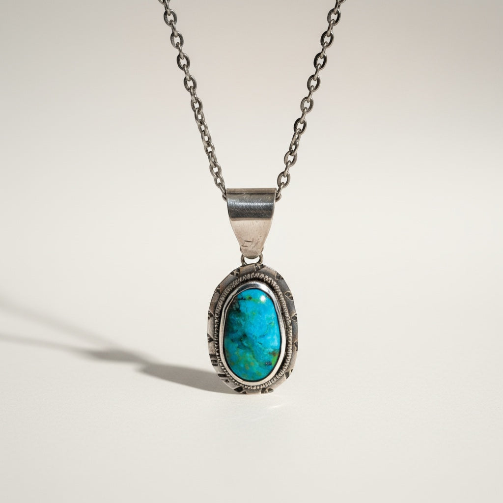 Bedrock Rose oval Kingman turquoise pendant in textured sterling silver with 18" chain and lobster clasp.