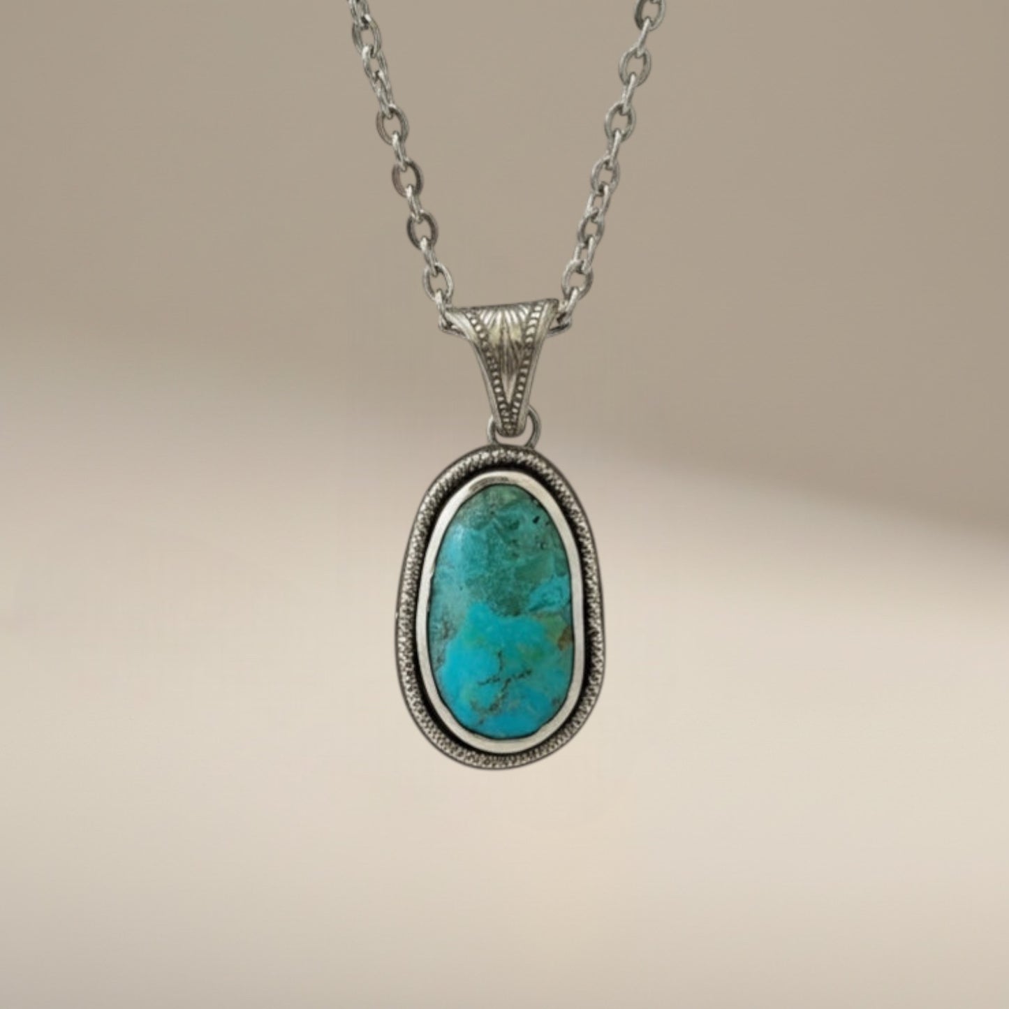 Bedrock Rose sterling silver pendant with oval Kingman turquoise gemstone, detailed bezel, and 18" cable chain.