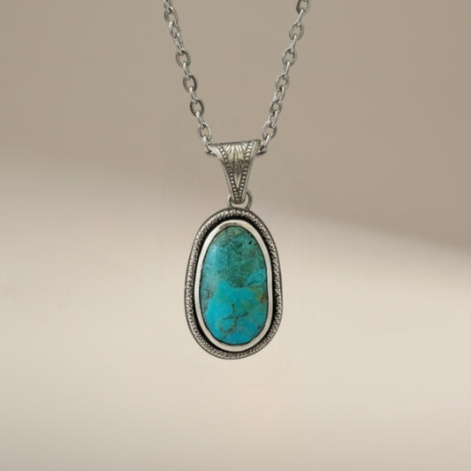 Bedrock Rose sterling silver pendant with oval Kingman turquoise gemstone, detailed bezel, and 18" cable chain.