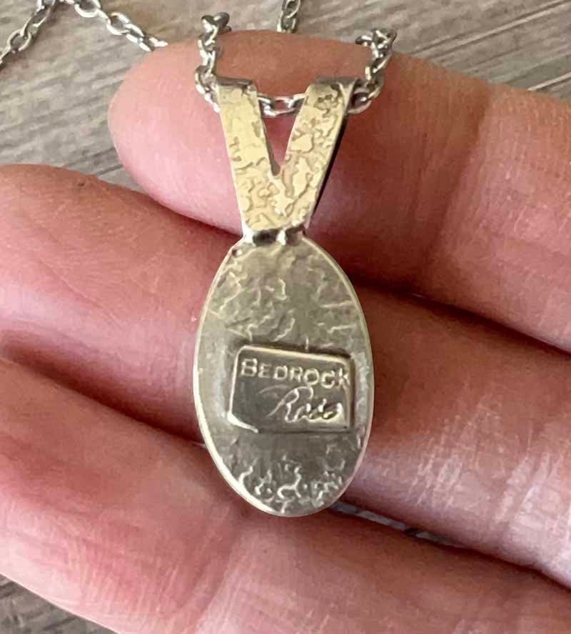 Bedrock Rose Kingman Turquoise pendant with silver bezel and 18" chain. Dainty oval pendant with faceted chain.