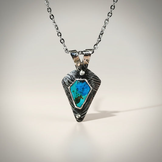 Bedrock Rose Kingman Turquoise sterling silver pendant with textured frame and faceted chain.