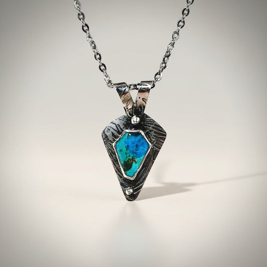 Bedrock Rose Kingman Turquoise sterling silver pendant with textured frame and faceted chain.
