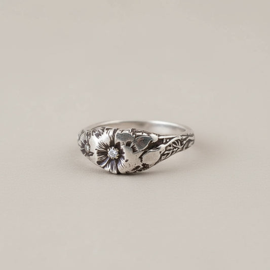 Bedrock Rose sterling silver ring featuring an October cosmos birth flower design. Size 7.75.