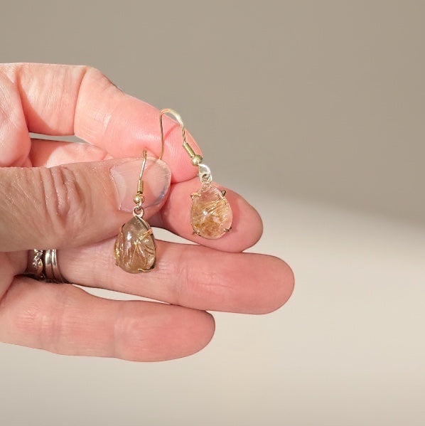 Bedrock Rose prong set pear rutilated quartz drop earrings with gold hooks.