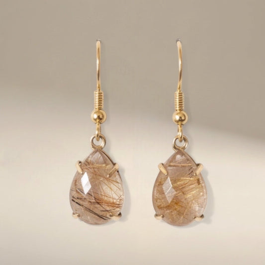Bedrock Rose Prong Set Pear Rutilated Quartz Earrings with gold hooks and faceted teardrop stones.