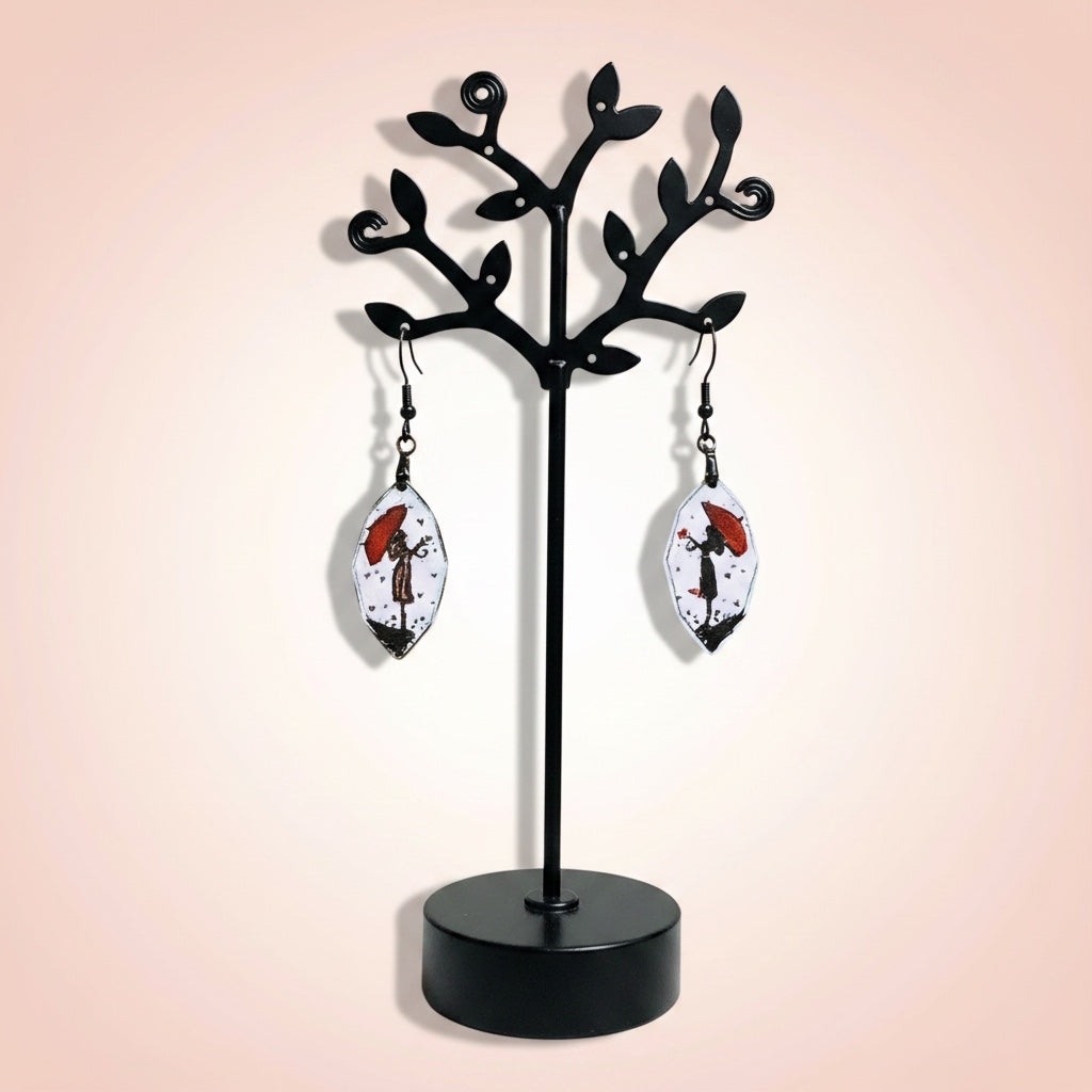 Bedrock Rose artisan shield earrings featuring hand-painted red umbrella silhouettes on white enamel.