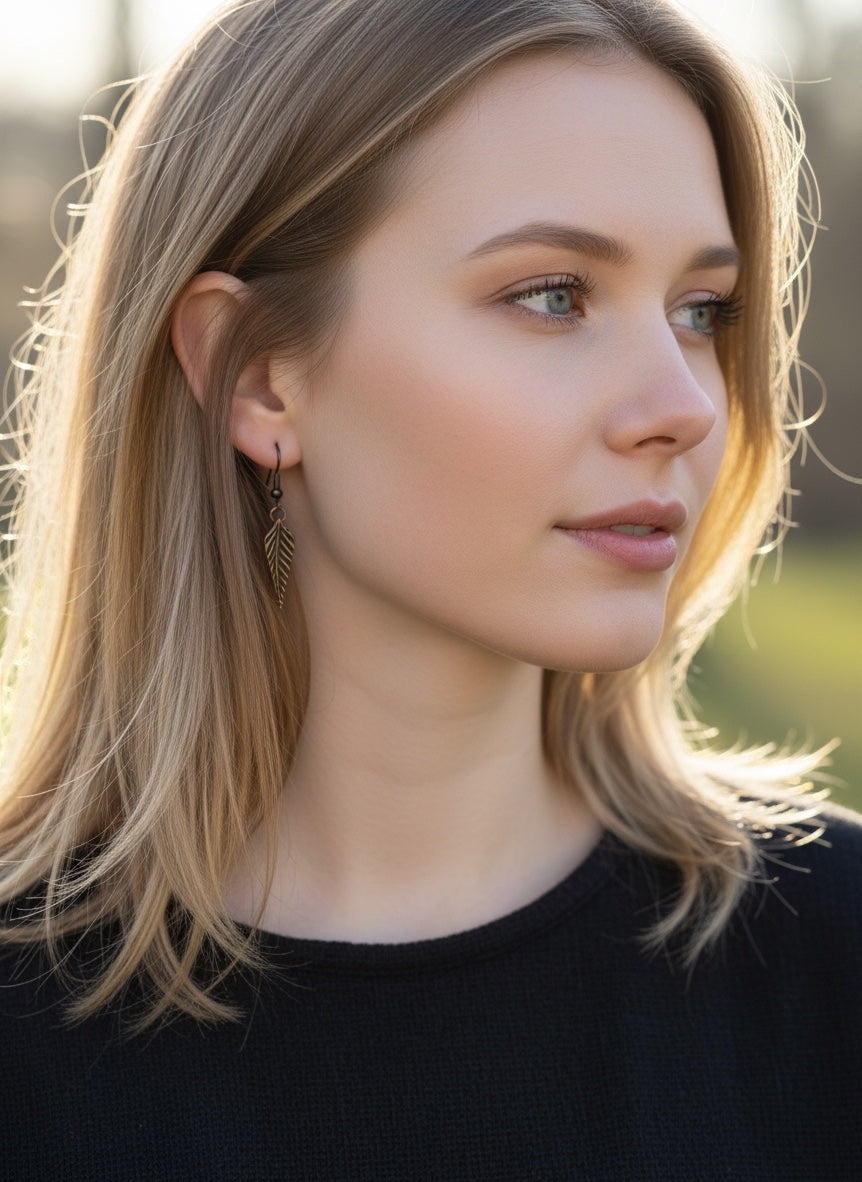 Bedrock Rose dainty rose bronze feather dangling earrings with surgical steel ear wires.