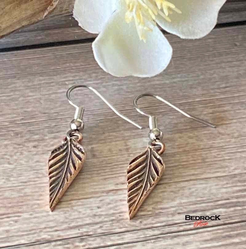 Bedrock Rose dainty rose bronze feather dangling earrings with surgical steel ear wires.