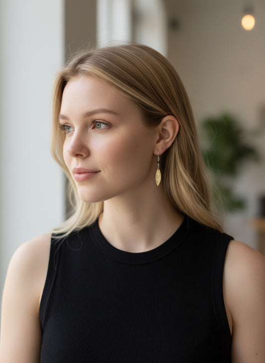 Bedrock Rose elongated rose bronze dangle earrings with floral texture and sterling silver ear wires.