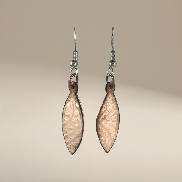 Bedrock Rose shiny copper oval dangling earrings with clear enamel and patterned design.
