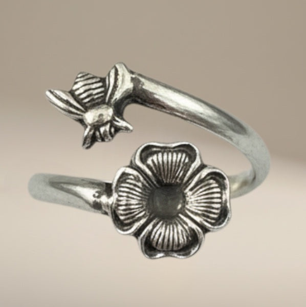 Bedrock Rose sterling silver wraparound ring with a bee landing on a flower, adjustable summer jewelry.