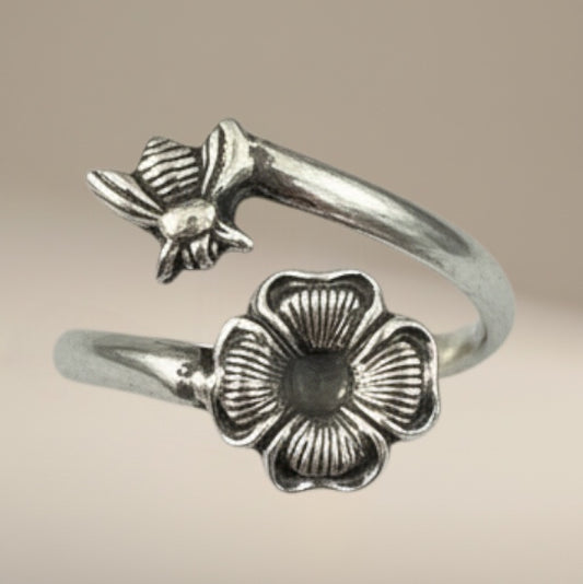 Bedrock Rose sterling silver wraparound ring with a bee landing on a flower, adjustable summer jewelry.