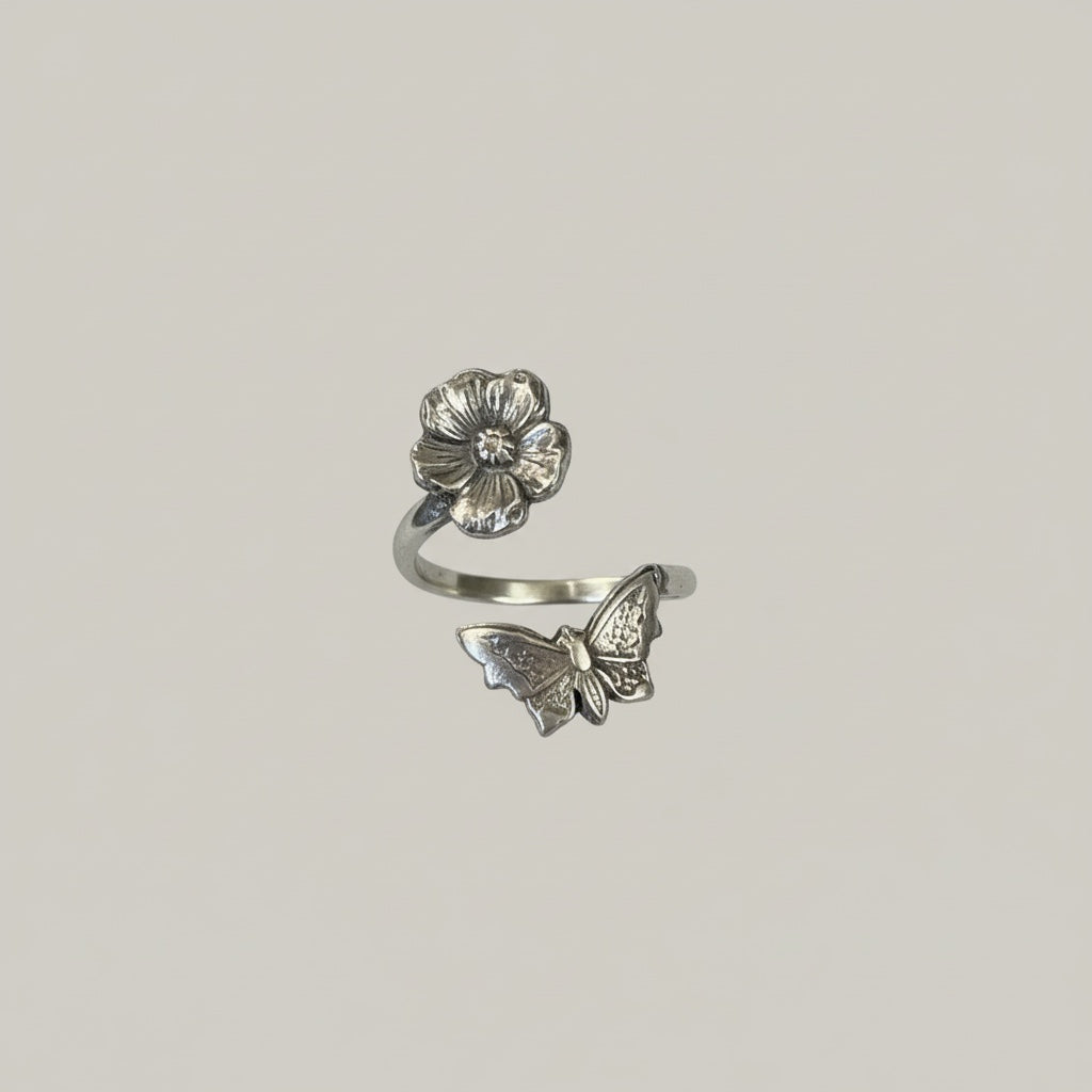 Bedrock Rose sterling silver wraparound ring with a butterfly and flower design. Adjustable summer jewelry.