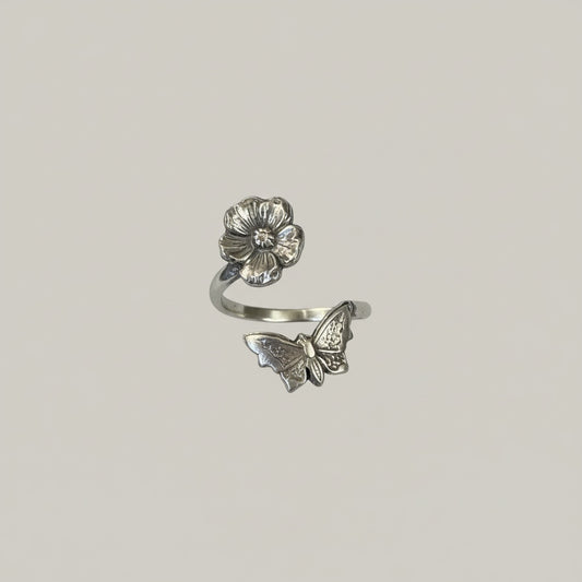 Bedrock Rose sterling silver wraparound ring with a butterfly and flower design. Adjustable summer jewelry.