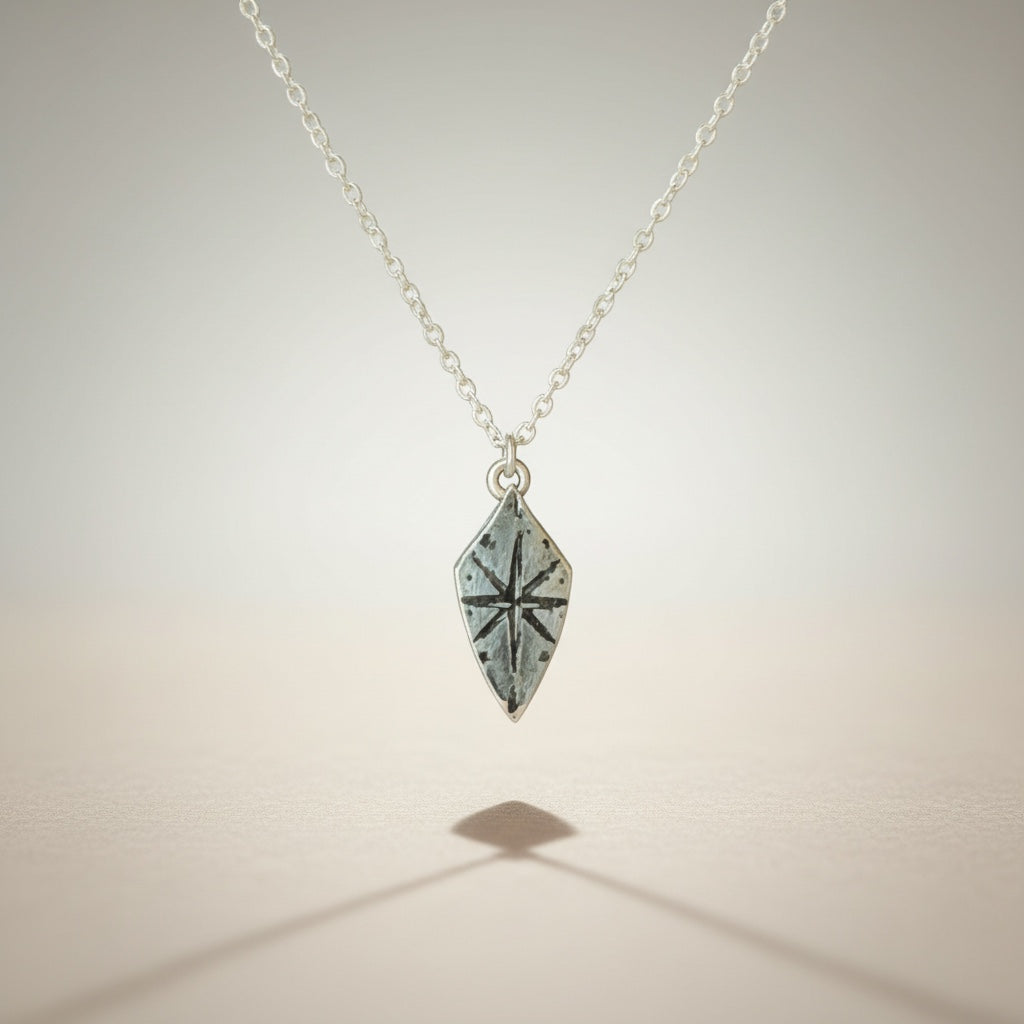 Bedrock Rose silver compass rose shield pendant necklace with a 16" sterling silver cable chain.