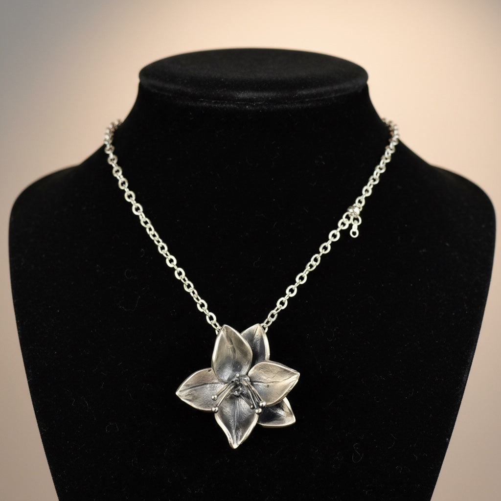 Bedrock Rose silver dogwood pendant necklace with a 1" diameter floral design on an 18.5" sterling silver chain.