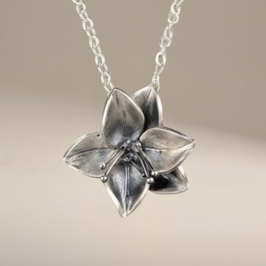 Bedrock Rose silver dogwood flower pendant necklace with sterling silver chain. Floral statement jewelry.
