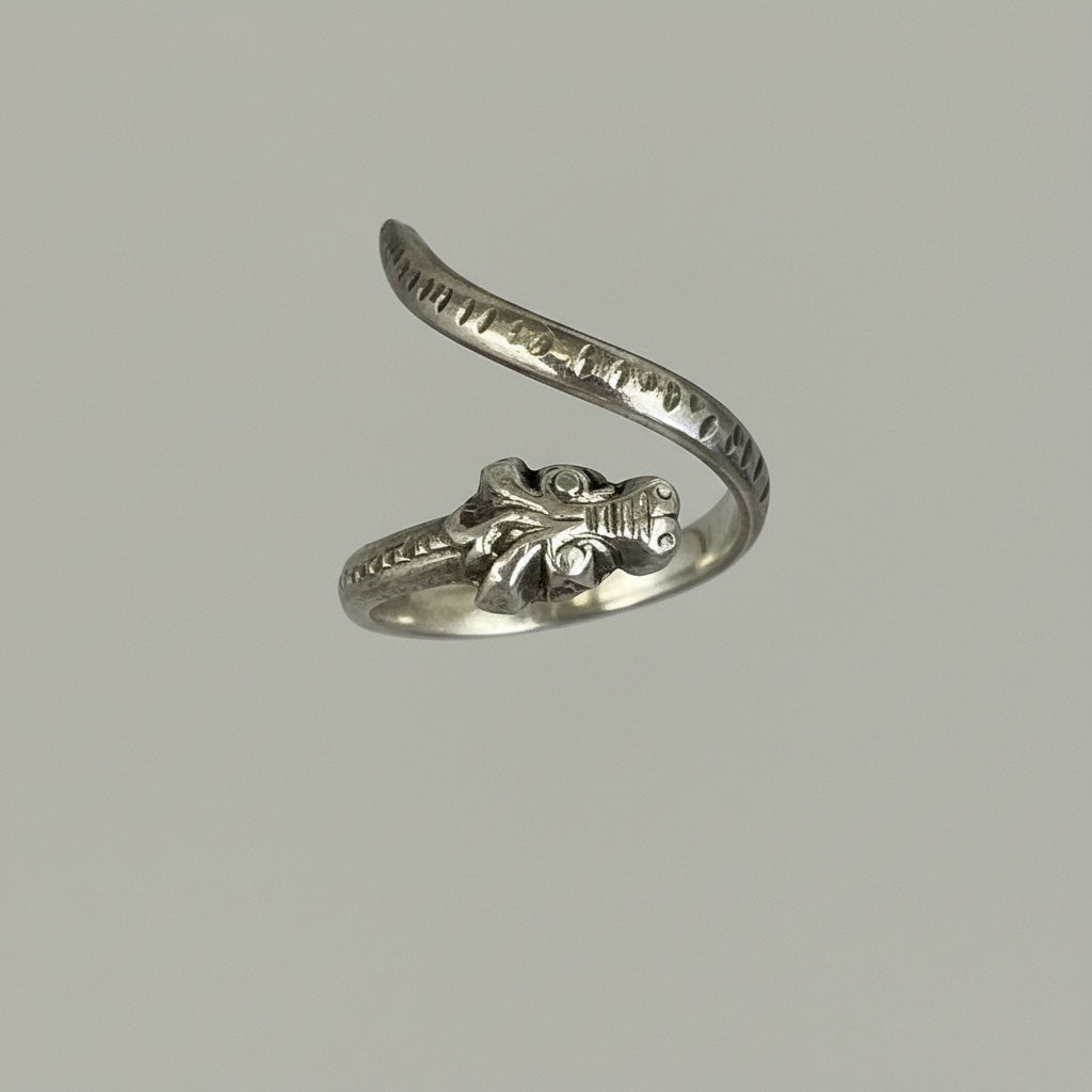 Bedrock Rose adjustable silver dragon wraparound ring with detailed head and textured band.