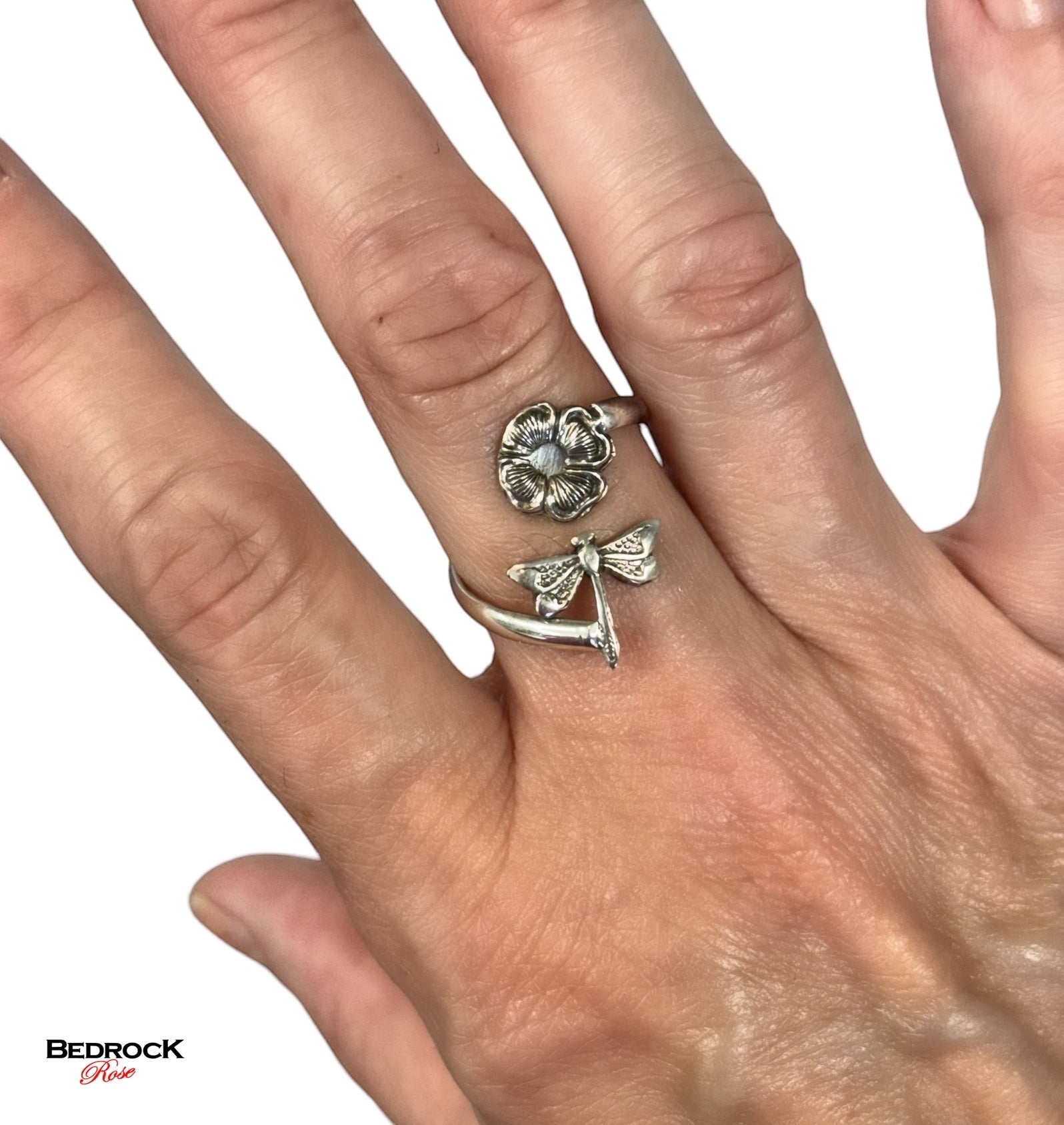Bedrock Rose sterling silver wraparound ring with a dragonfly landing on a flower. Adjustable summer jewelry.