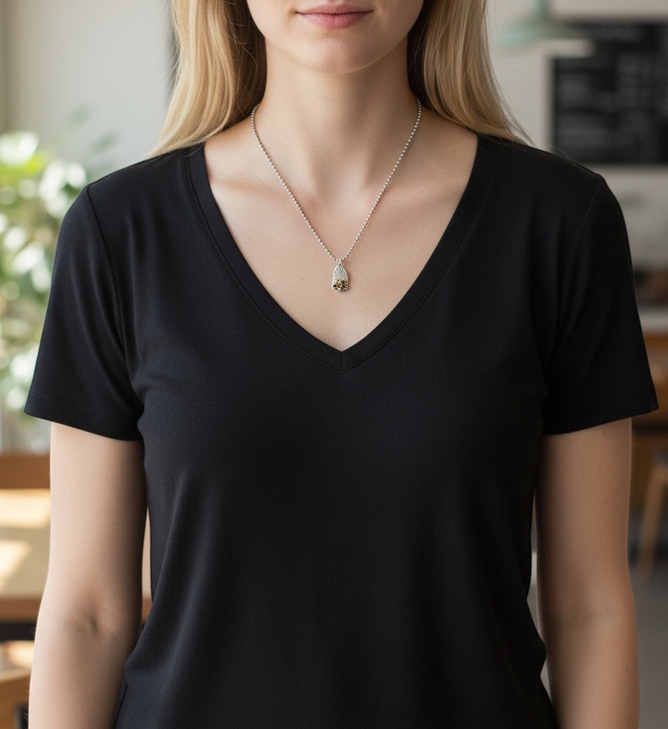Bedrock Rose silver and gold pendant necklace featuring a detailed rose on a textured background with a silver ball chain.