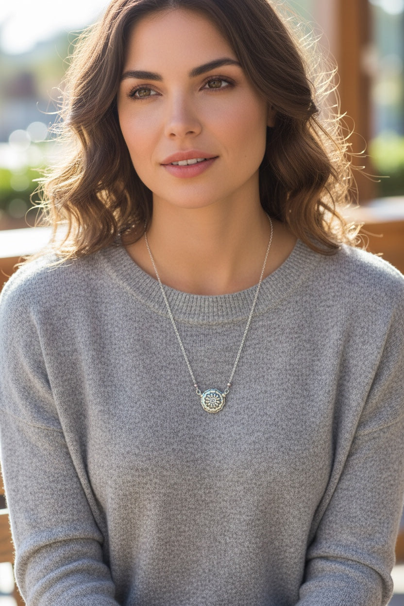 Bedrock Rose silver double-sided mandala pendant necklace with intricate floral design and small colorful beads.