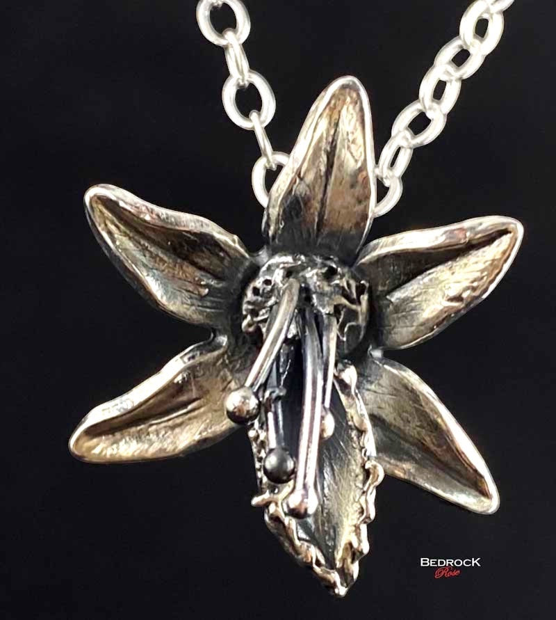 Bedrock Rose fine silver orchid pendant necklace with intricate petal detail and stamen.