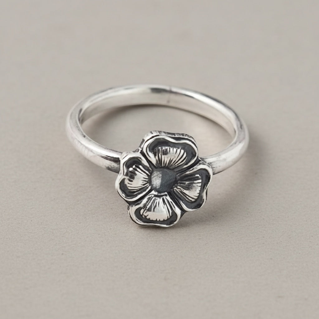 Bedrock Rose silver ring with a four-petal primrose flower design. Size 5.25.