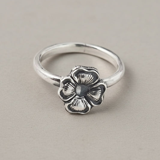 Bedrock Rose silver ring with a four-petal primrose flower design. Size 5.25.