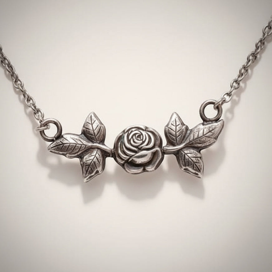 Bedrock Rose silver pendant necklace with a detailed rose and leaf design. Elegant floral jewelry.