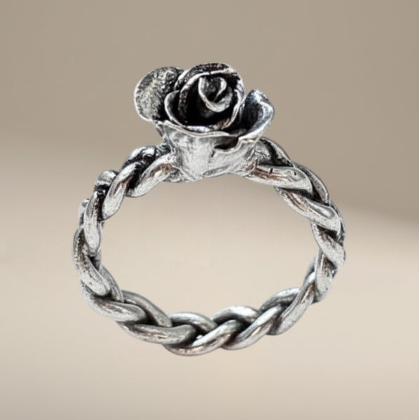 Bedrock Rose hand-sculpted fine silver ring with rosebud detail on braided band, size 8.