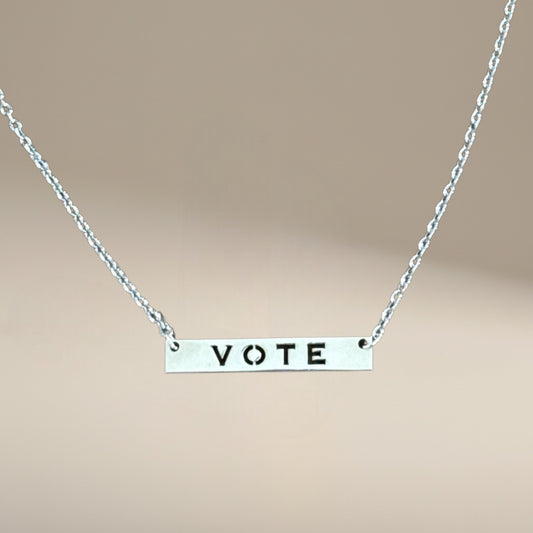 Bedrock Rose silver vote necklace with laser-cut sterling silver pendant on a hypoallergenic stainless steel chain.