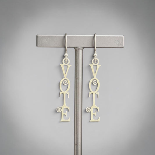 Bedrock Rose sterling silver dangling earrings with the word "Vote" in a fancy scroll design. Laser-cut, elegant, and perfect for showing support for democracy.