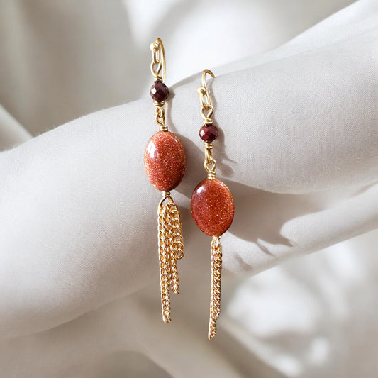 Bedrock Rose gold chain dangling earrings with oval sunstone stones and small garnet beads.