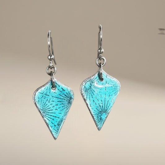Bedrock Rose teal green arabesque dangling earrings with a sparkly, patterned design.