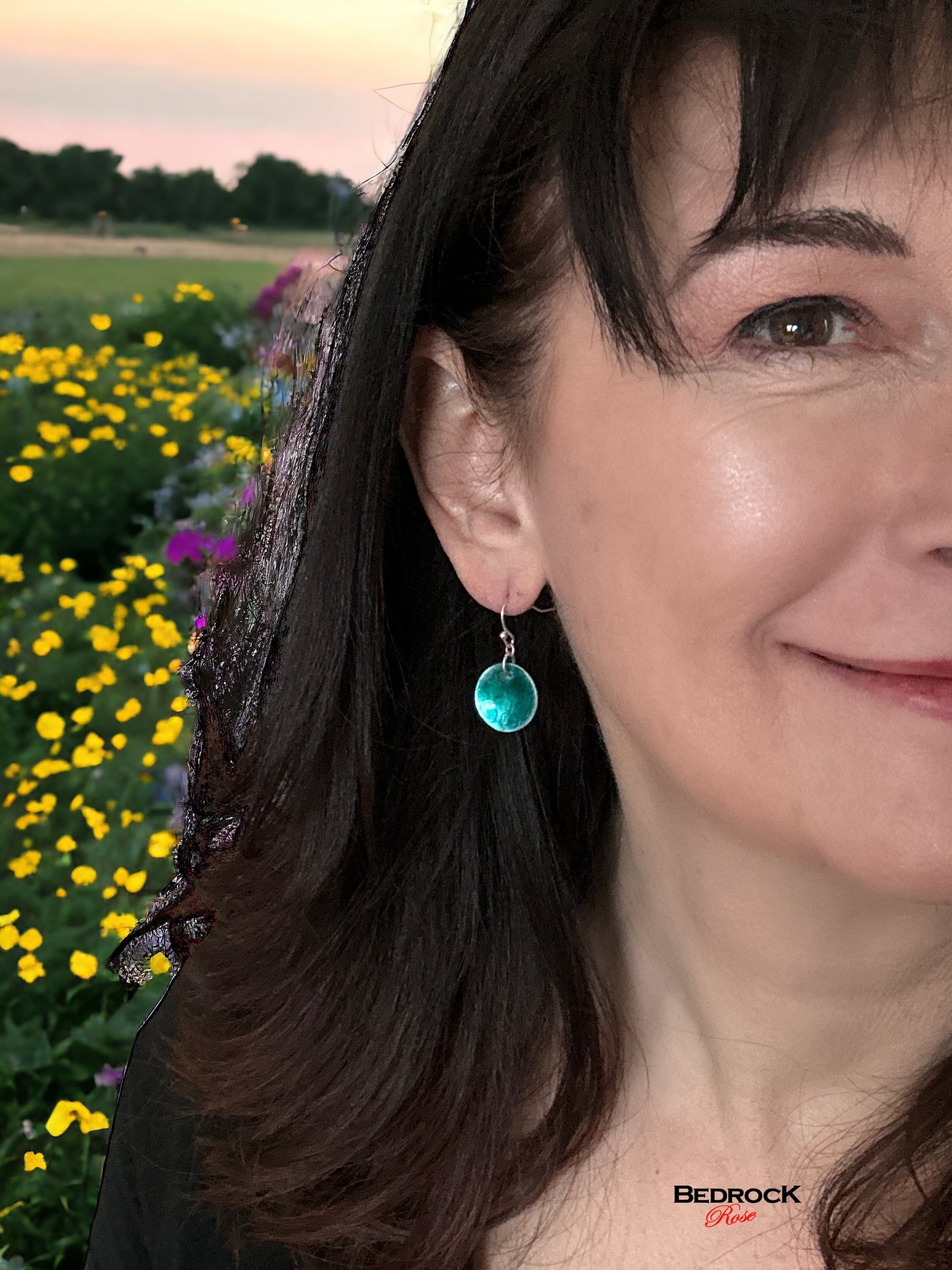 Bedrock Rose transparent green circular dangling earrings with honeycomb pattern.