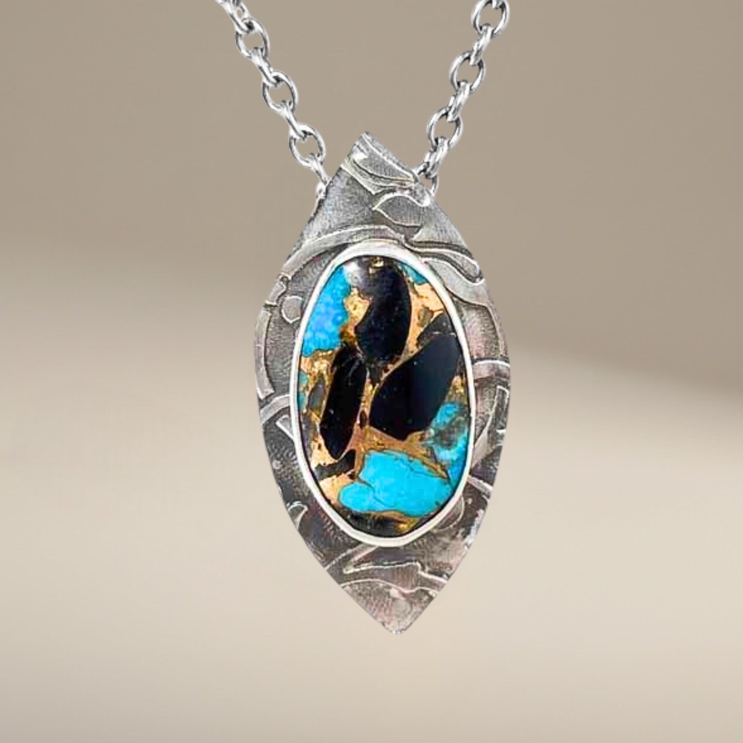 Bedrock Rose pendant with Kingman turquoise, onyx, and bronze inlay in a textured sterling silver frame. Includes a 19" chain.