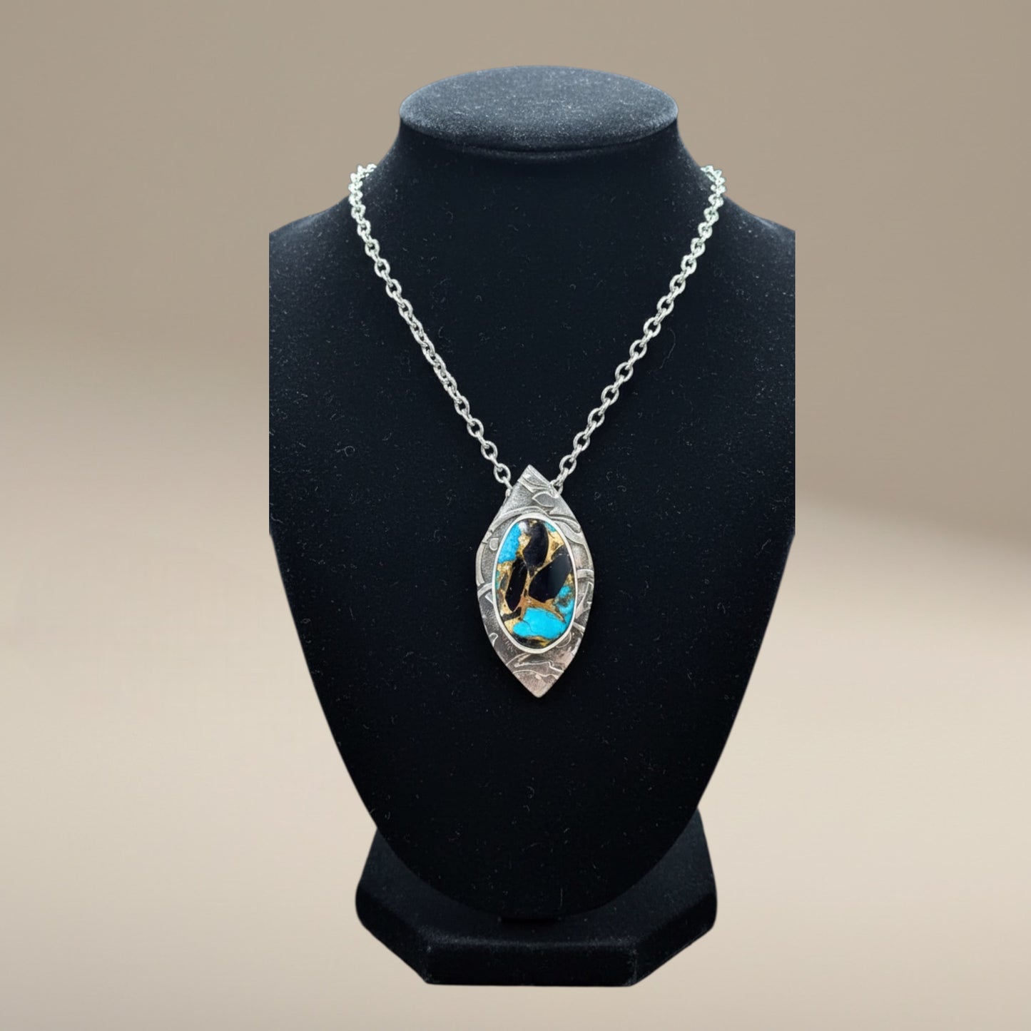 Bedrock Rose pendant with Kingman turquoise, onyx, and bronze inlay in a textured sterling silver frame.