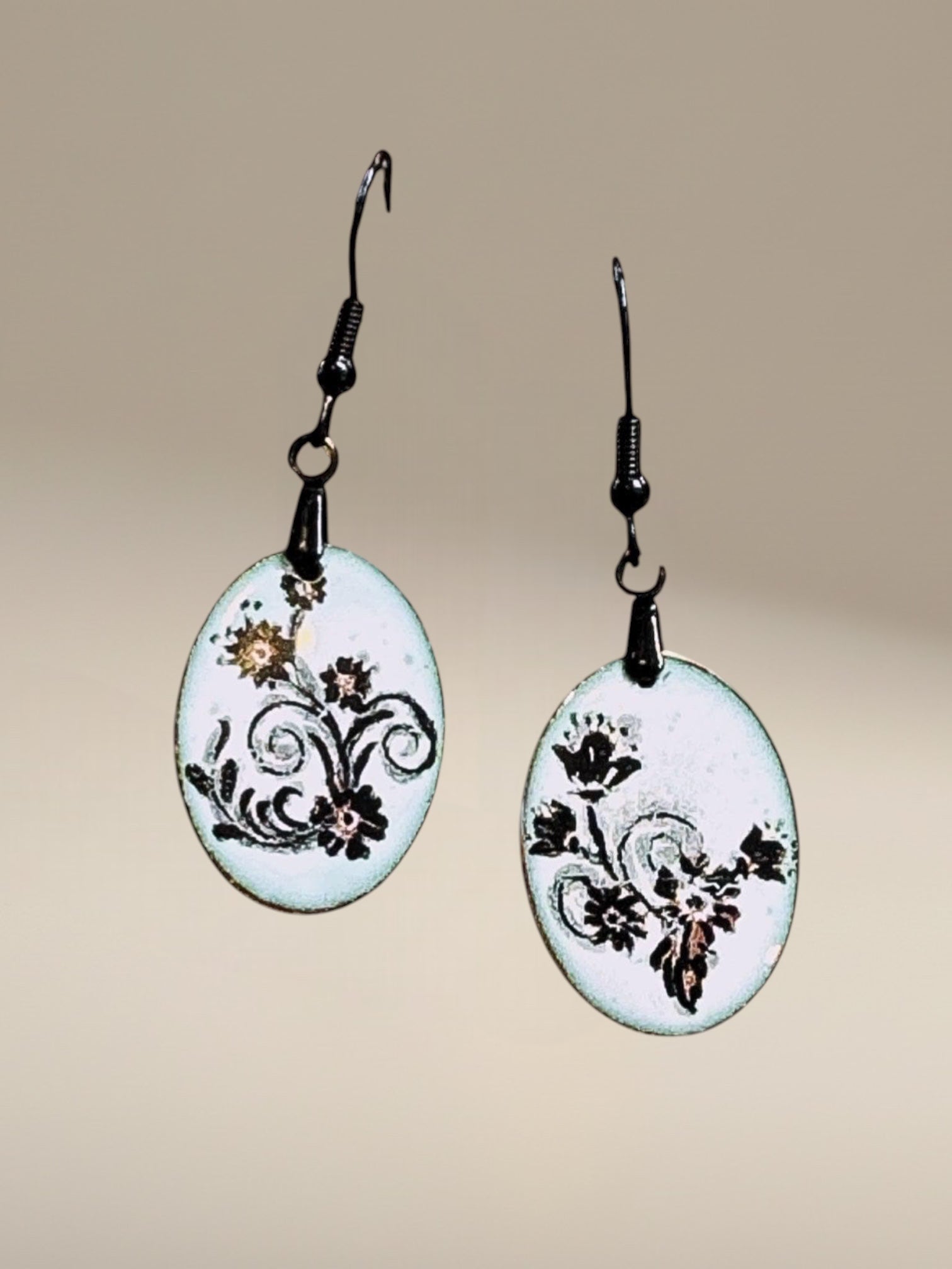 Bedrock Rose petite oval dangle earrings with black floral scroll enamel on white. 12x22mm.