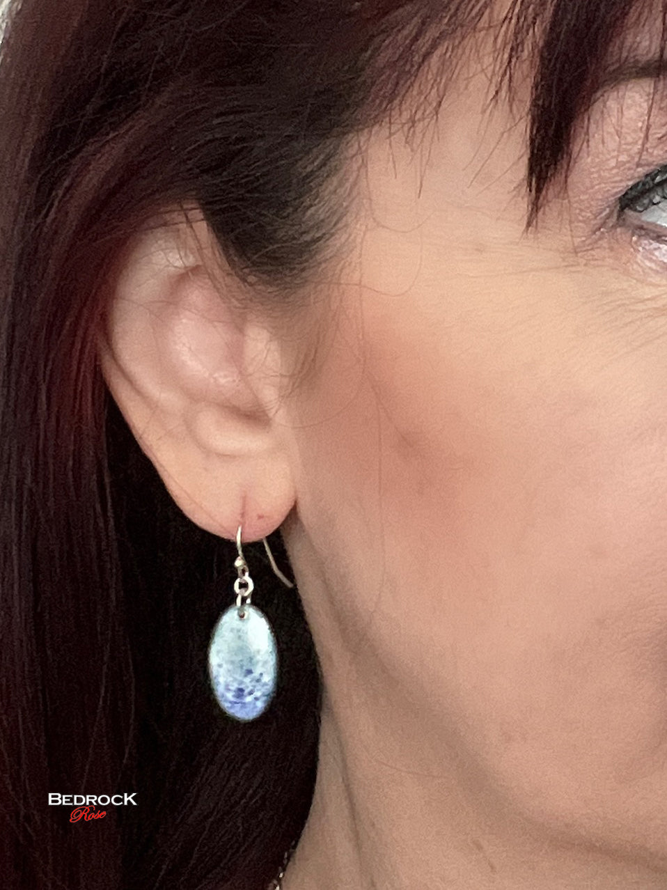 Blue on white speckled dangling earrings.
